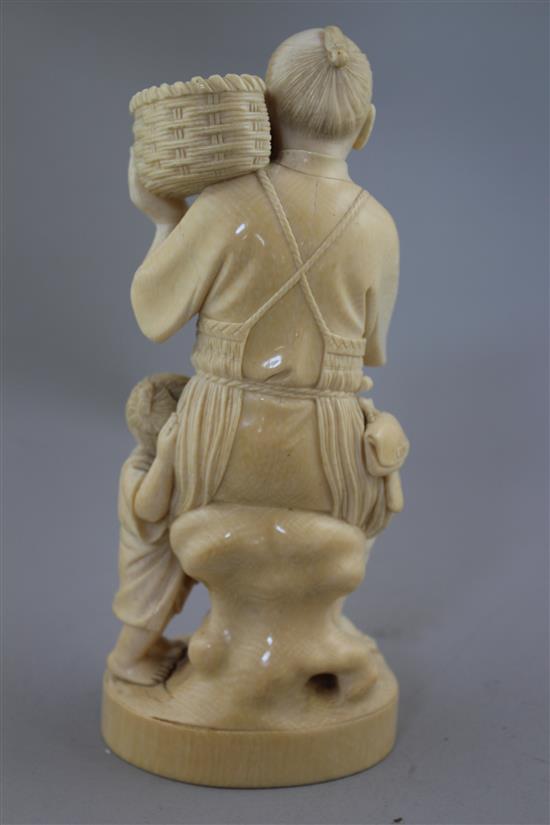 A Japanese ivory group of a fisherman and a boy, early 20th century, 13.5cm, age cracks